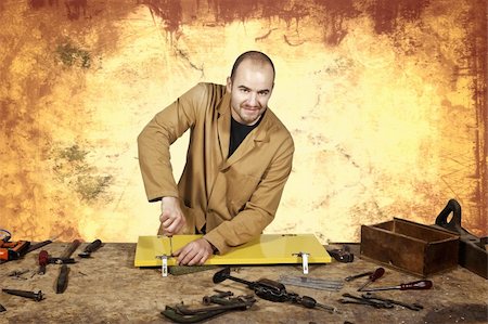 simsearch:400-08531083,k - craftsman at work and brown grunge background Stock Photo - Budget Royalty-Free & Subscription, Code: 400-04651828