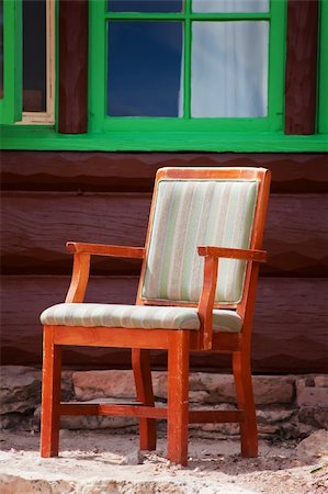 Rustic chair outside log cabin with green window Stock Photo - Budget Royalty-Free & Subscription, Code: 400-04651978