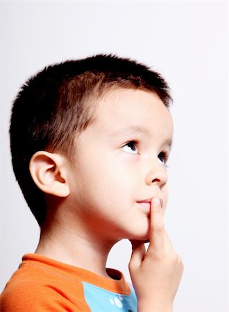 boy thinking and looking up over white background Foto de stock - Royalty-Free Super Valor e Assinatura, Número: 400-04652070