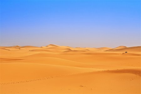 sahara desert terrain - wide view of sand dunes, footsteps in foreground Stock Photo - Budget Royalty-Free & Subscription, Code: 400-04652134