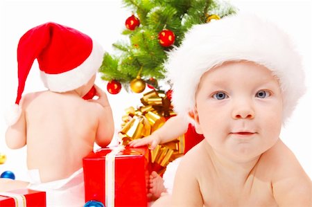 Little friends  sitting beside Christmas tree Stock Photo - Budget Royalty-Free & Subscription, Code: 400-04652298