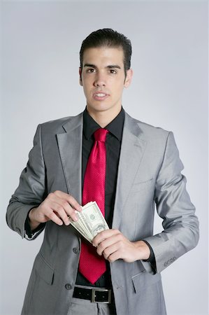 Businessman young with dollar notes suit and tie on gray background Stock Photo - Budget Royalty-Free & Subscription, Code: 400-04652469