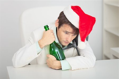The young guy in a Christmas cap with a bottle Stock Photo - Budget Royalty-Free & Subscription, Code: 400-04652934