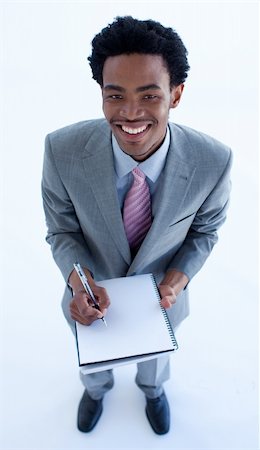 Afro-American businessman writing notes in a notebook Stock Photo - Budget Royalty-Free & Subscription, Code: 400-04653002
