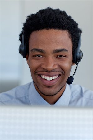 Portrait of a smiling Afro-American businessman working in a call center Stock Photo - Budget Royalty-Free & Subscription, Code: 400-04653064