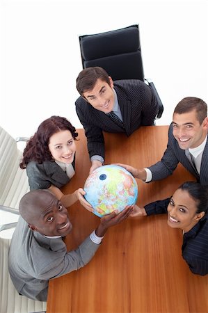 simsearch:400-05087119,k - High Angle of smiling team holding a globe in a meeting. Global business Foto de stock - Royalty-Free Super Valor e Assinatura, Número: 400-04653209