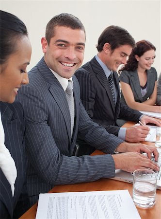 simsearch:400-04187718,k - Attractive businessman in a meeting smiling at the camera Foto de stock - Royalty-Free Super Valor e Assinatura, Número: 400-04653200