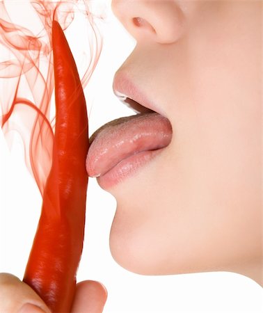 simsearch:400-07899696,k - girl close up licking chili pepper  isolated on white Photographie de stock - Aubaine LD & Abonnement, Code: 400-04653303