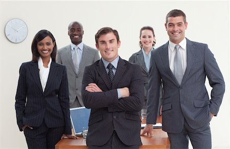 simsearch:400-04187718,k - Confident business team standing in a meeting and smiling at the camera Foto de stock - Royalty-Free Super Valor e Assinatura, Número: 400-04653311