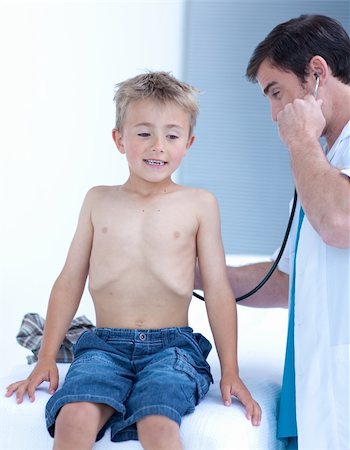 pneumoniae - Attractive doctor examinating a little boy with stethoscope Stock Photo - Budget Royalty-Free & Subscription, Code: 400-04653383