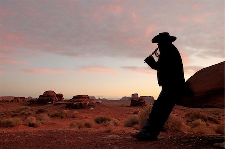 simsearch:400-04019213,k - Mid adult male wearing cowboy hat and playing the flute. He is full length viewable, looking away from the camera and in silhouette. Horizontally framed shot. Stock Photo - Budget Royalty-Free & Subscription, Code: 400-04653445