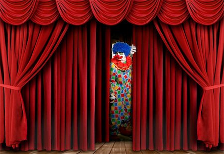 A clown on stage behind a red curtain, looking away from the camera and full length viewable. Horizontally framed shot. Stock Photo - Budget Royalty-Free & Subscription, Code: 400-04653448