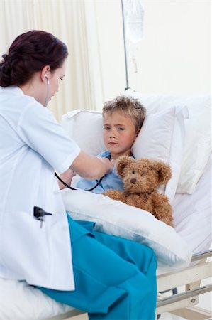 sick boy with teddy - Female doctor listening to a child chest with stethoscope in bed Stock Photo - Budget Royalty-Free & Subscription, Code: 400-04653506