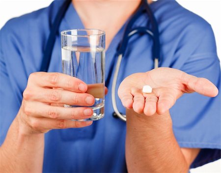 Close-up of a pill and a glass of water hold by a doctor Stock Photo - Budget Royalty-Free & Subscription, Code: 400-04653509