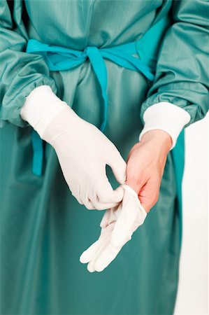 Young surgeon before an operation with gloves Stock Photo - Budget Royalty-Free & Subscription, Code: 400-04653511