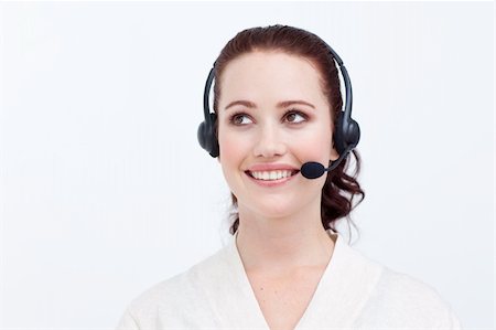 simsearch:400-03990860,k - Beautiful businesswoman with a headset on looking upwards against white background Photographie de stock - Aubaine LD & Abonnement, Code: 400-04653520