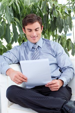 simsearch:400-05687698,k - Attractive satisfied businessman reading papers on a sofa Stock Photo - Budget Royalty-Free & Subscription, Code: 400-04653550