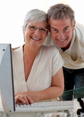 retirement home group - Happy senior couple using a computer at home Stock Photo - Budget Royalty-Free & Subscription, Code: 400-04653620