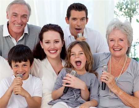 Family singing karaoke with microphones at home Stock Photo - Budget Royalty-Free & Subscription, Code: 400-04653631