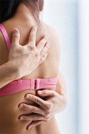 Hand supporting breast cancer victim, on the back of woman using bra with one strap only Stock Photo - Budget Royalty-Free & Subscription, Code: 400-04653697