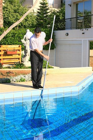 reflective pool and house - Swimming pool cleaner at  work. Stock Photo - Budget Royalty-Free & Subscription, Code: 400-04664040