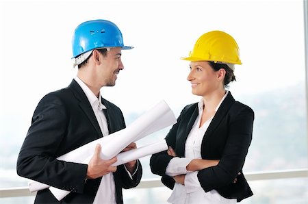 smiling industrial workers group photo - young arhitect group in big bright modern new apartment looking blueprints and building plans Stock Photo - Budget Royalty-Free & Subscription, Code: 400-04664109