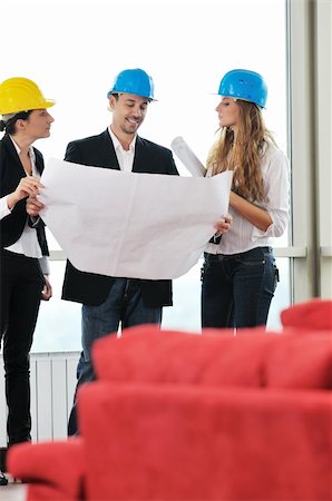 smiling industrial workers group photo - young arhitect group in big bright modern new apartment looking blueprints and building plans Stock Photo - Budget Royalty-Free & Subscription, Code: 400-04664114