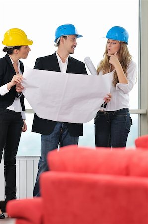 young arhitect group in big bright modern new apartment looking blueprints and building plans Stock Photo - Budget Royalty-Free & Subscription, Code: 400-04664113
