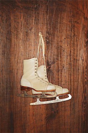 A Pair of old women's old skates hanging on a wooden wall. Photographed with a ring flash. Stock Photo - Budget Royalty-Free & Subscription, Code: 400-04664229