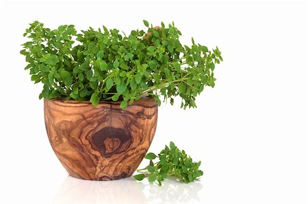 simsearch:400-04348087,k - Sweet Italian basil in an olive wood mortar with pestle, isolated over white background with reflection. Stock Photo - Budget Royalty-Free & Subscription, Code: 400-04664572