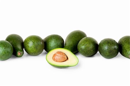 One avocado in front of several more on white background Stock Photo - Budget Royalty-Free & Subscription, Code: 400-04664761