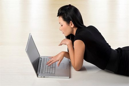 beautiful young oriental woman using a laptop and laying down on the floor Stock Photo - Budget Royalty-Free & Subscription, Code: 400-04664780