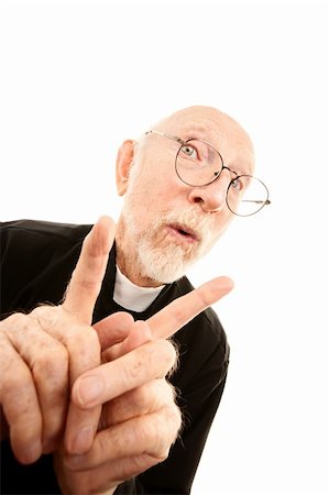 simsearch:400-04278950,k - Senior priest holding up index fingers on each hand Fotografie stock - Microstock e Abbonamento, Codice: 400-04664982