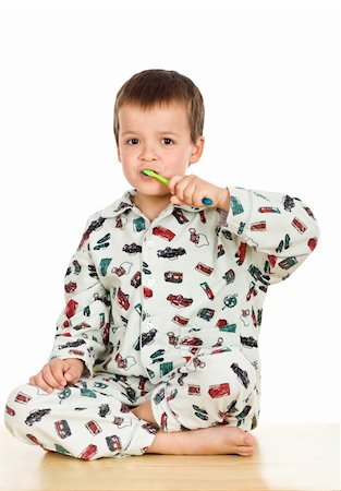 Kid brushing teeth before bedtime - isolated Stock Photo - Budget Royalty-Free & Subscription, Code: 400-04665035