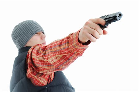 simsearch:632-01145244,k - Young man is aiming with gun. Isolated on white. Photographie de stock - Aubaine LD & Abonnement, Code: 400-04665567
