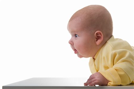 simsearch:400-05727835,k - Young baby boy creeps on a table, over white background Fotografie stock - Microstock e Abbonamento, Codice: 400-04665865