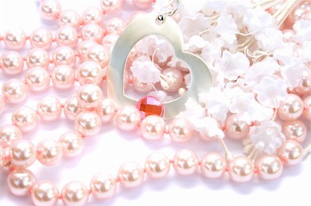 simsearch:693-06022199,k - Necklace with pink stone on it,pearls and fabric flowers on white background. Photographie de stock - Aubaine LD & Abonnement, Code: 400-04666098