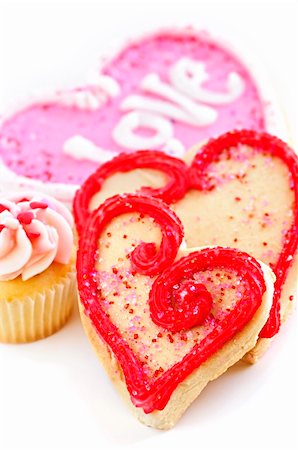 simsearch:400-07549504,k - Homemade baked shortbread Valentine cookies and cupcake with icing on white background Photographie de stock - Aubaine LD & Abonnement, Code: 400-04666425