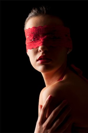 sensual portrait of a young brunette on black background with a red mask of lace Photographie de stock - Aubaine LD & Abonnement, Code: 400-04666786