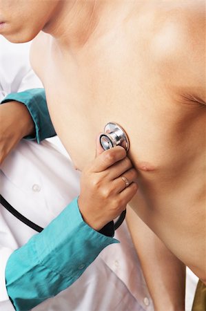 doctor check up with heartbeat - Doctor checking patient heart beat with stethoscope Stock Photo - Budget Royalty-Free & Subscription, Code: 400-04666856