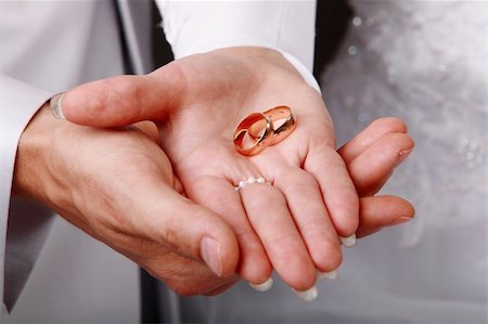 Image of a young couple holding wedding rings on hands Stock Photo - Budget Royalty-Free & Subscription, Code: 400-04666893