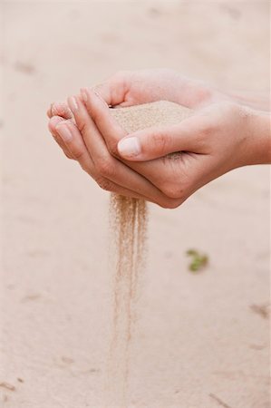 simsearch:700-00748140,k - Sand flows through female fingers Stock Photo - Budget Royalty-Free & Subscription, Code: 400-04669374