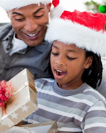 Portrait of a happy Afro-American father and son opening a Christmas gift Stock Photo - Budget Royalty-Free & Subscription, Code: 400-04660008