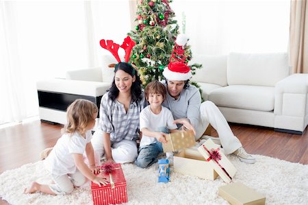happy family opening Christmas presents at home Stock Photo - Budget Royalty-Free & Subscription, Code: 400-04660020