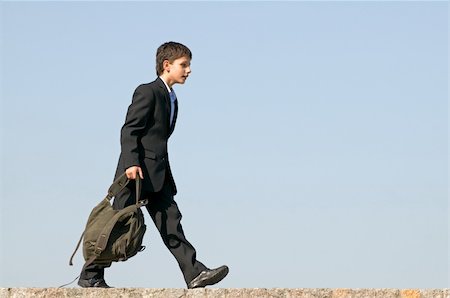 simsearch:400-04643781,k - a successful school student is walking home holding his schoolbag in his hands Stock Photo - Budget Royalty-Free & Subscription, Code: 400-04660040