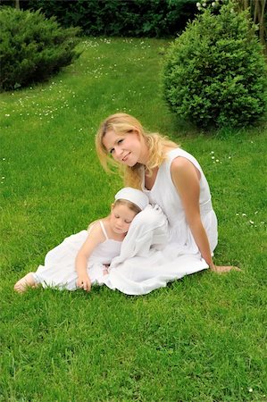 Young mother and daughter resting in meadow Stock Photo - Budget Royalty-Free & Subscription, Code: 400-04660057