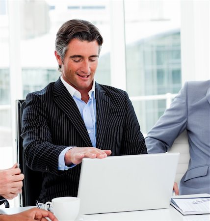 simsearch:400-07102453,k - Portrait of a confident businessman using a laptop in a meeting Stock Photo - Budget Royalty-Free & Subscription, Code: 400-04660297