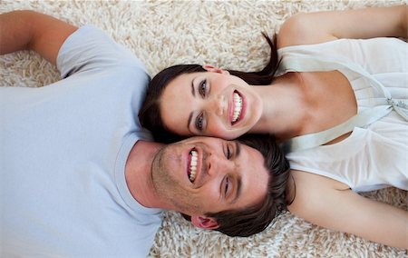 Smiling Couple lying on the floor with heads together Stock Photo - Budget Royalty-Free & Subscription, Code: 400-04660465