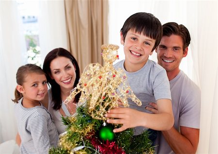 simsearch:400-07088886,k - Smiling family decorating a Christmas tree at home Stock Photo - Budget Royalty-Free & Subscription, Code: 400-04660704