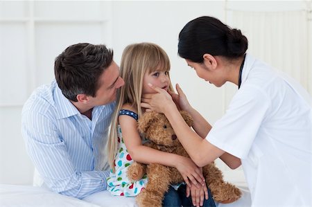 Female doctor examining little girl accompanied by her father Stock Photo - Budget Royalty-Free & Subscription, Code: 400-04660719